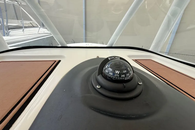 Slide: The Image of Compass on 2016 Sea Fox 226 Commander boat dashboard, featuring Ritchie navigation instrument. - 16