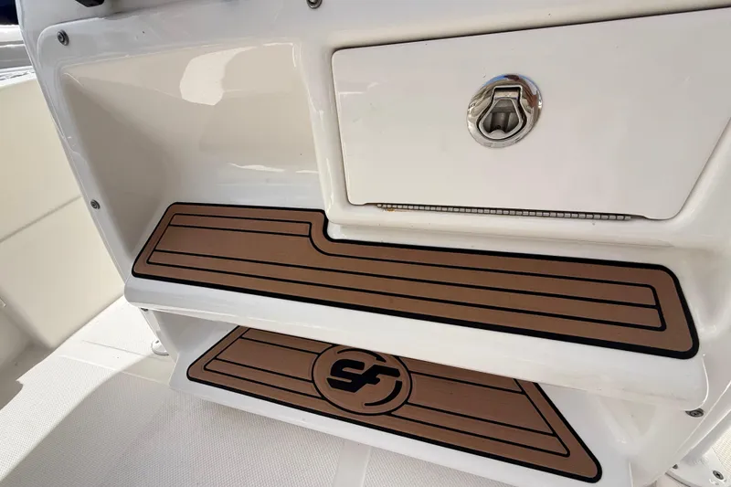 Slide: The Image of 2016 Sea Fox 226 Commander boat interior with storage compartment and non-slip mats. - 17