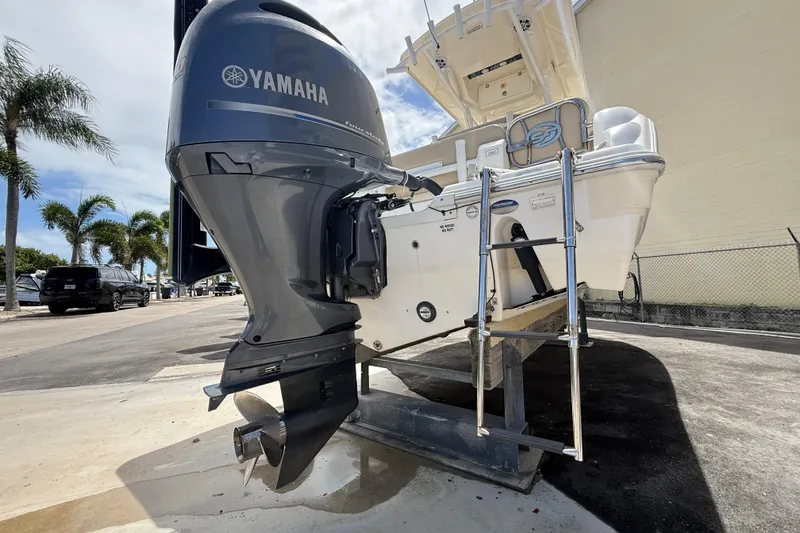 Slide: The Image of 2016 Sea Fox 226 Commander boat with Yamaha outboard motor and ladder, parked outdoors. - 22