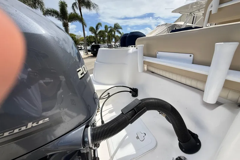 Slide: The Image of 2016 Sea Fox 226 Commander boat with Yamaha 200 engine, docked under palm trees. - 25
