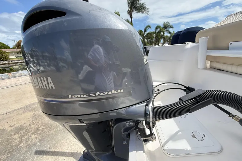 Slide: The Image of 2016 Sea Fox 226 Commander with Yamaha four-stroke engine, docked under a sunny sky. - 26