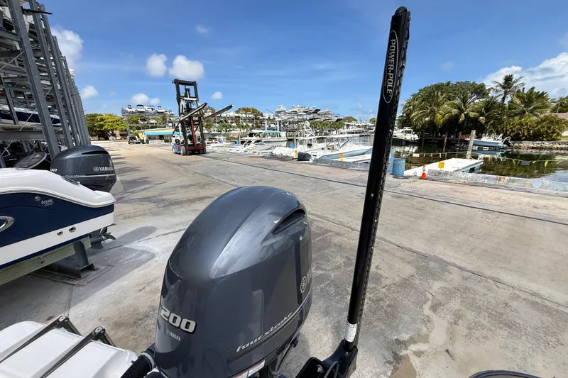 Slide: The Image of 2016 Sea Fox 226 Commander at marina with Yamaha outboard, docked boats, and palm trees. - 28