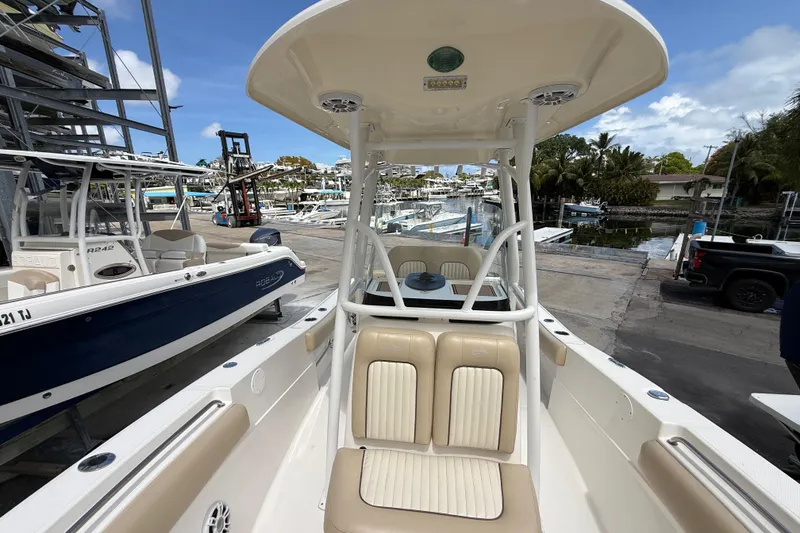 Slide: The Image of 2016 Sea Fox 226 Commander boat docked at marina, showcasing seating and helm. - 29
