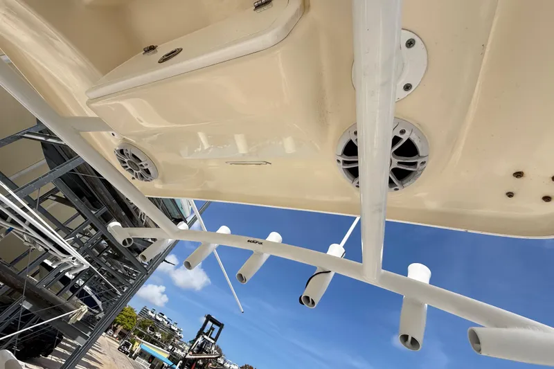 Slide: The Image of 2016 Sea Fox 226 Commander boat underside with rod holders and speakers, docked under clear sky. - 32