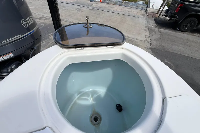 Slide: The Image of Open livewell on a 2016 Sea Fox 226 Commander boat, with Yamaha outboard engine visible. - 34