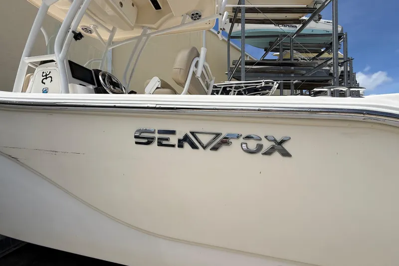 Slide: The Image of 2016 Sea Fox 226 Commander boat side view with logo and interior details. - 4