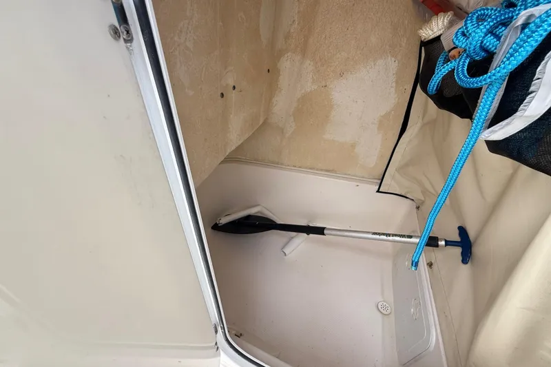 Slide: The Image of Storage compartment of a 2016 Sea Fox 226 Commander boat with blue rope and paddle. - 49