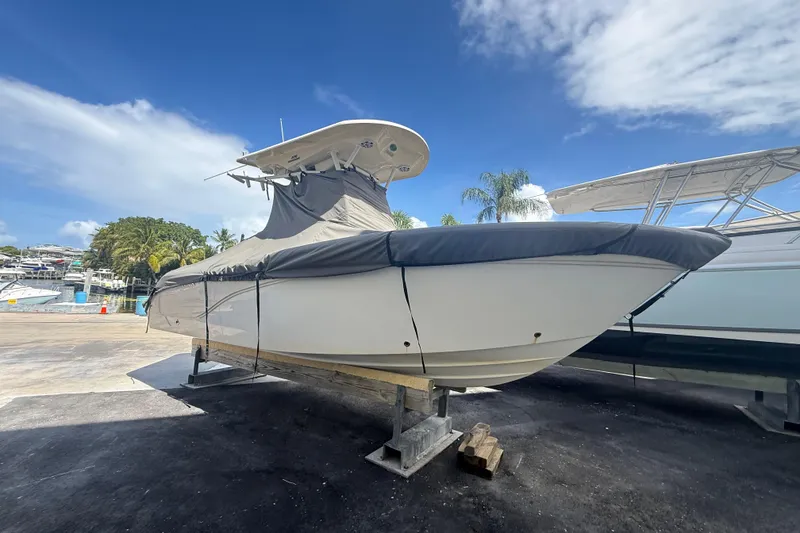 Slide: The Image of 2016 Sea Fox 226 Commander boat covered and docked under a clear blue sky. - 7