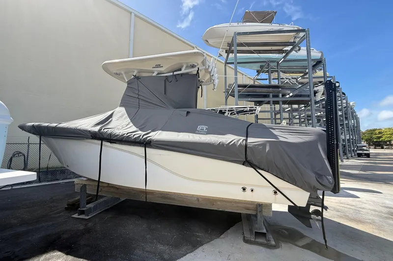 Slide: The Image of 2016 Sea Fox 226 Commander boat covered and stored on a rack outdoors. - 8