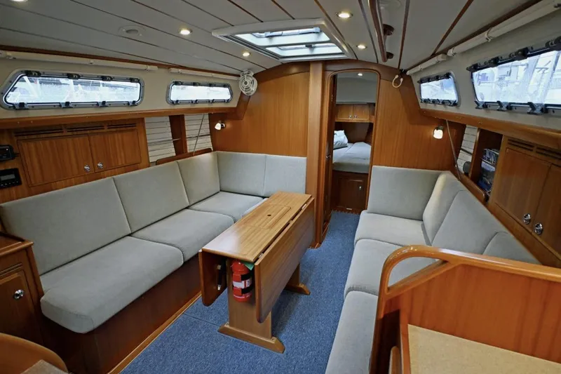 Slide: The Image of Luxurious interior of 2020 Hallberg Rassy 310 yacht with cozy seating and wooden finishes. - 11