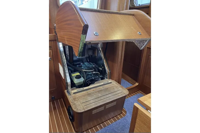 Slide: The Image of Engine compartment of a 2020 Hallberg Rassy 310 sailboat, showcasing wooden interior design. - 12