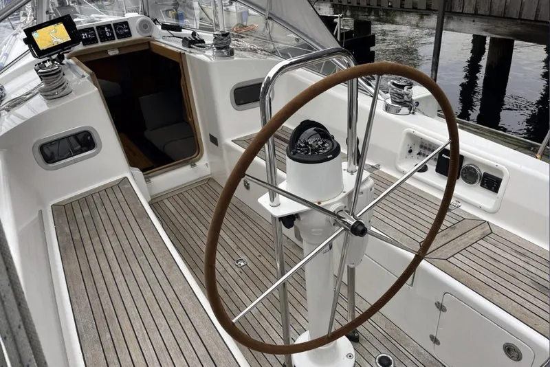 Slide: The Image of Cockpit of 2020 Hallberg Rassy 310 sailboat with wooden steering wheel and navigation instruments. - 15