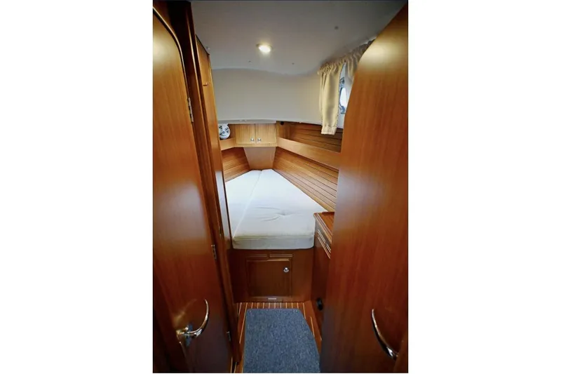 Slide: The Image of Cozy cabin interior of 2020 Hallberg Rassy 310 yacht with wooden finish and bed. - 3