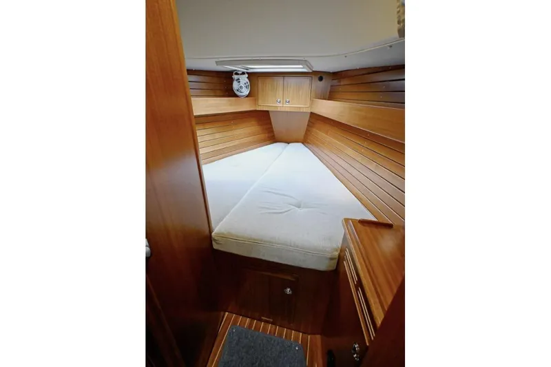 Slide: The Image of Cozy cabin interior of 2020 Hallberg Rassy 310 yacht with wooden paneling. - 4