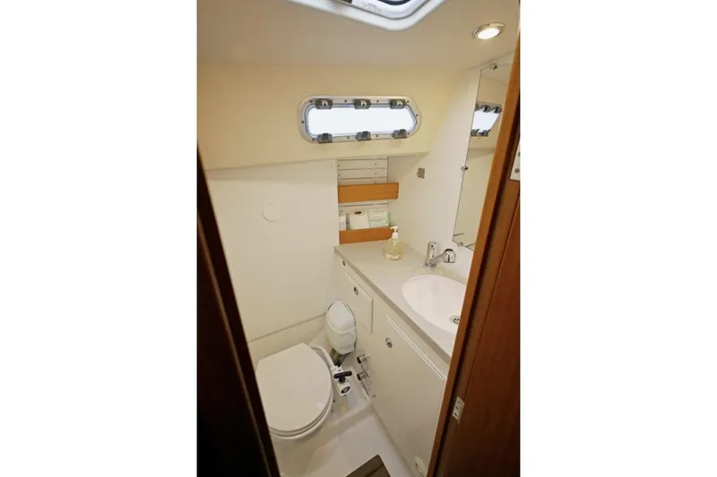 Slide: The Image of Compact bathroom in a 2020 Hallberg Rassy 310 yacht, featuring a toilet and sink. - 5