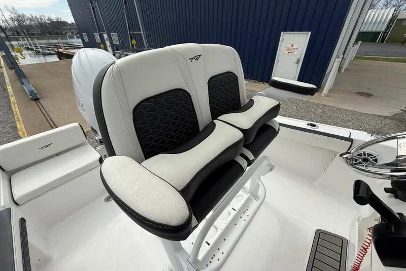 Slide: The Image of 2025 Tidewater 198 CC Adventure boat with dual cushioned seats and steering wheel. - 15