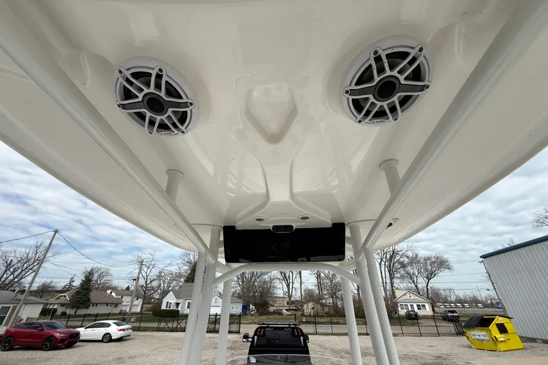 Slide: The Image of 2025 Tidewater 198 CC Adventure boat speakers and T-top view. - 17