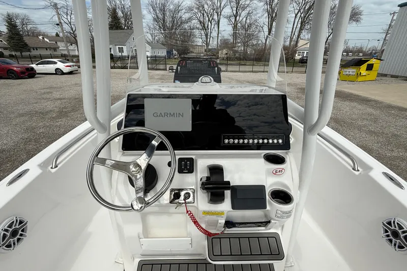Slide: The Image of 2025 Tidewater 198 CC Adventure boat console with Garmin navigation system and steering wheel. - 18