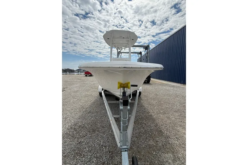 Slide: The Image of 2025 Tidewater 198 CC Adventure boat on trailer under cloudy sky. - 19