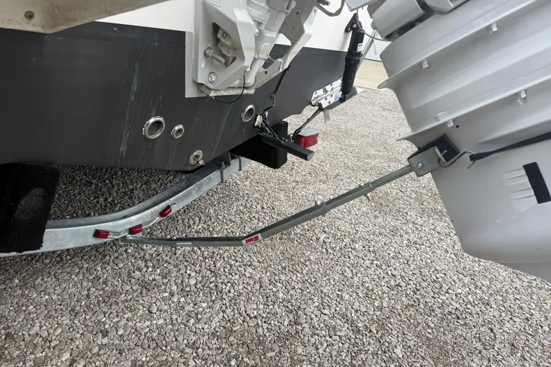 Slide: The Image of Rear view of 2025 Tidewater 198 CC Adventure boat on trailer, showcasing engine and hull details. - 3