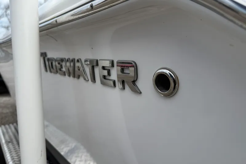 Slide: The Image of 2025 Tidewater 198 CC Adventure boat, close-up of logo and hull detail. - 5