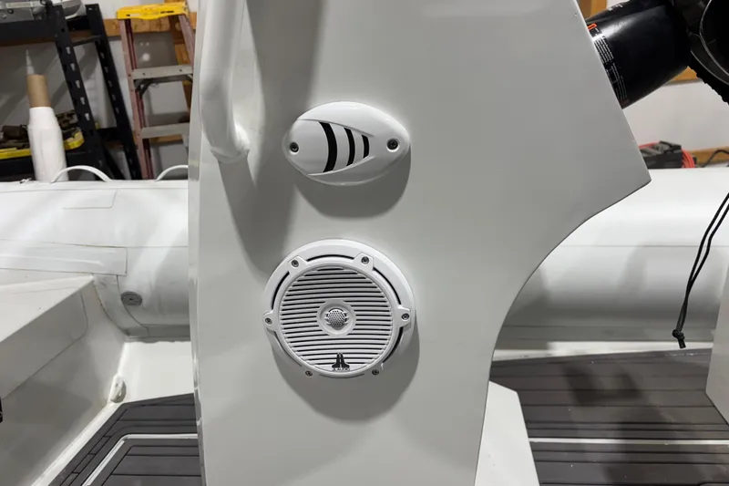 Slide: The Image of 2026 Airrib 18 boat console with speaker and control panel in a workshop setting. - 4