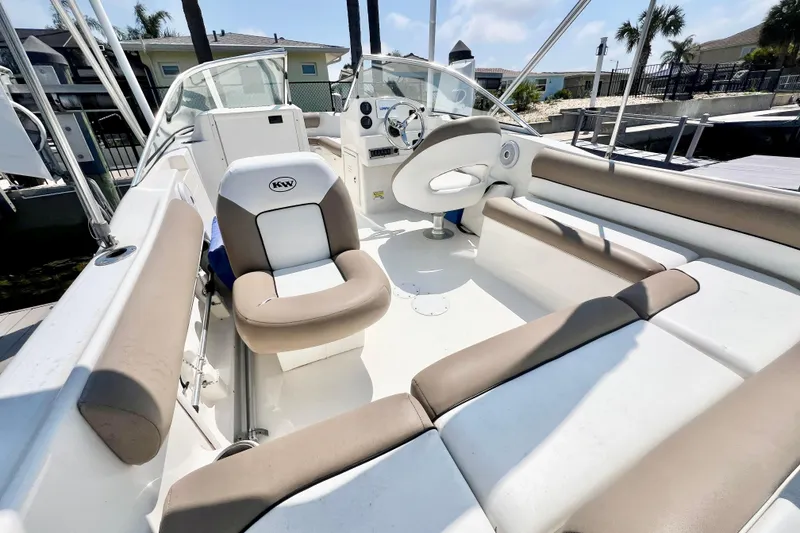 Slide: The Image of 2013 Key West 203 DFS boat interior with beige and white seating, steering wheel, and dashboard. - 3
