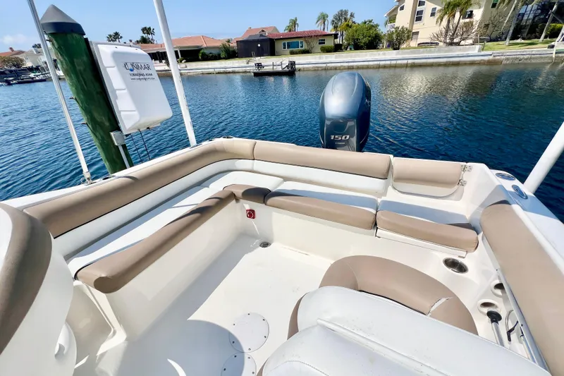 Slide: The Image of 2013 Key West 203 DFS boat interior with seating, docked by waterfront homes. - 4