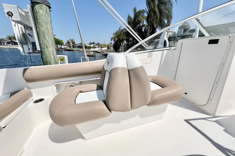 Slide: The Image of 2013 Key West 203 DFS boat interior with beige seating and waterfront view. - 5