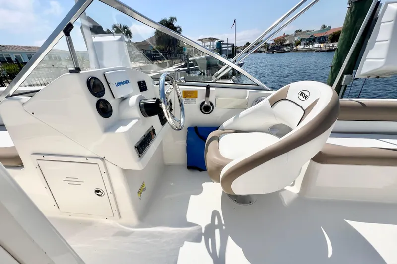 Slide: The Image of 2013 Key West 203 DFS boat cockpit with steering wheel and comfortable seating. - 6