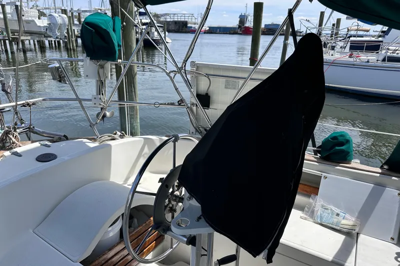 Slide: The Image of Cockpit of a 1986 Pacific Seacraft 34 sailboat, featuring a covered steering wheel. - 13