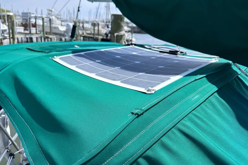 Slide: The Image of Solar panel on green canvas of 1986 Pacific Seacraft 34 sailboat in marina. - 14