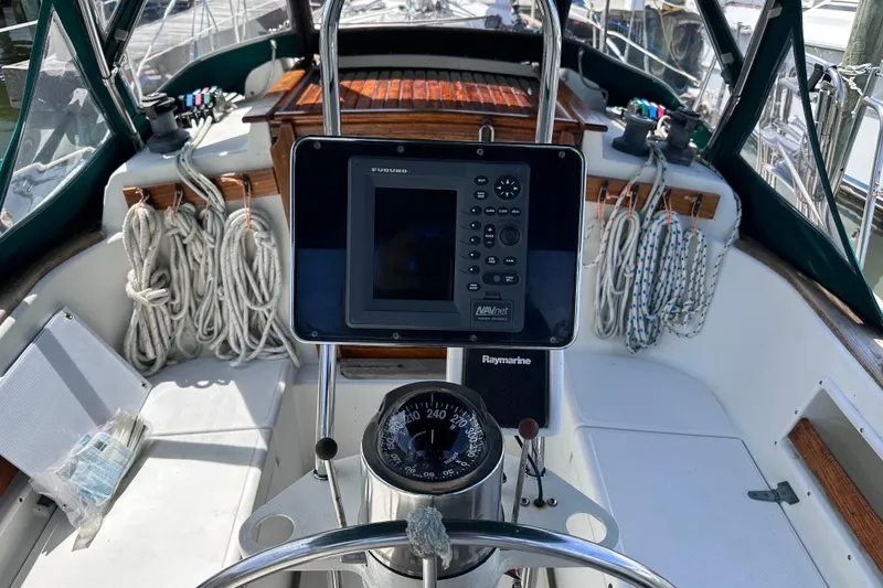 Slide: The Image of Cockpit of 1986 Pacific Seacraft 34 sailboat with navigation equipment and ropes. - 17