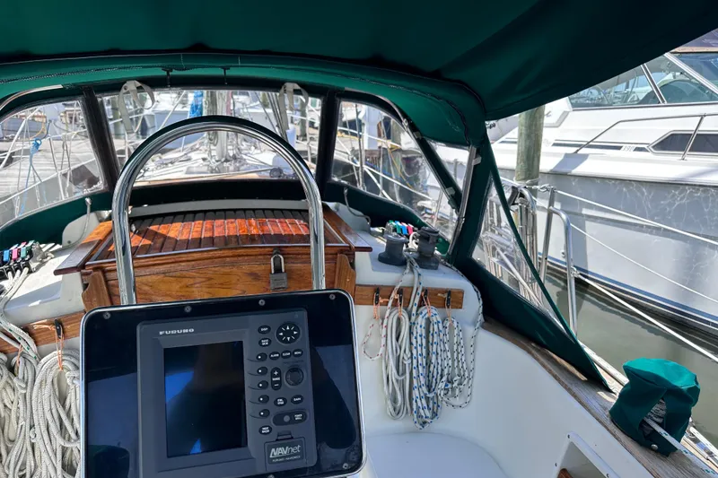 Slide: The Image of Cockpit of 1986 Pacific Seacraft 34 sailboat with navigation equipment and ropes. - 18