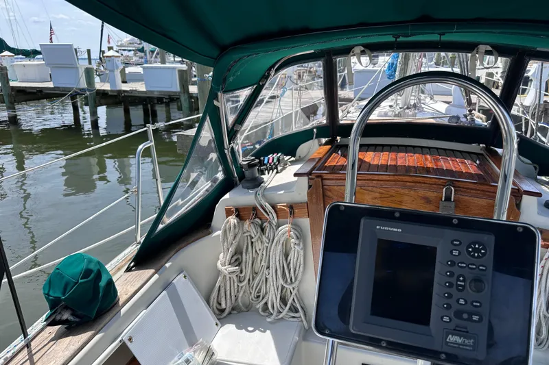 Slide: The Image of Cockpit of a 1986 Pacific Seacraft 34 sailboat with navigation equipment and ropes. - 19