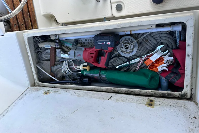 Slide: The Image of Storage compartment on a 1986 Pacific Seacraft 34 sailboat, filled with tools and equipment. - 20