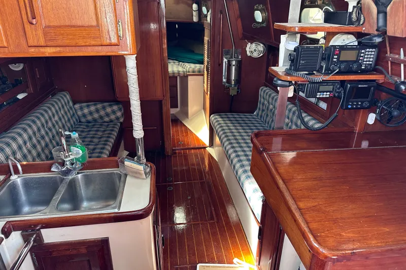 Slide: The Image of Interior of 1986 Pacific Seacraft 34 sailboat with wood finish and plaid seating. - 22