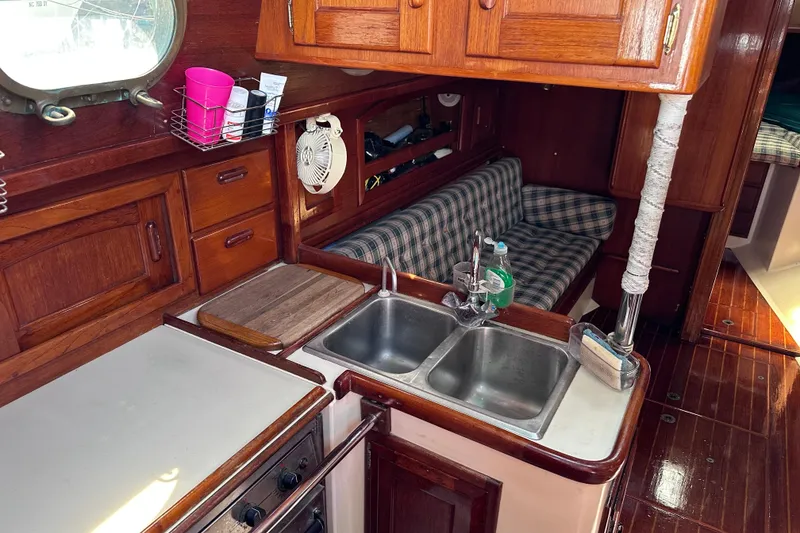Slide: The Image of Interior of 1986 Pacific Seacraft 34 sailboat with wooden cabinetry and dual sink. - 23