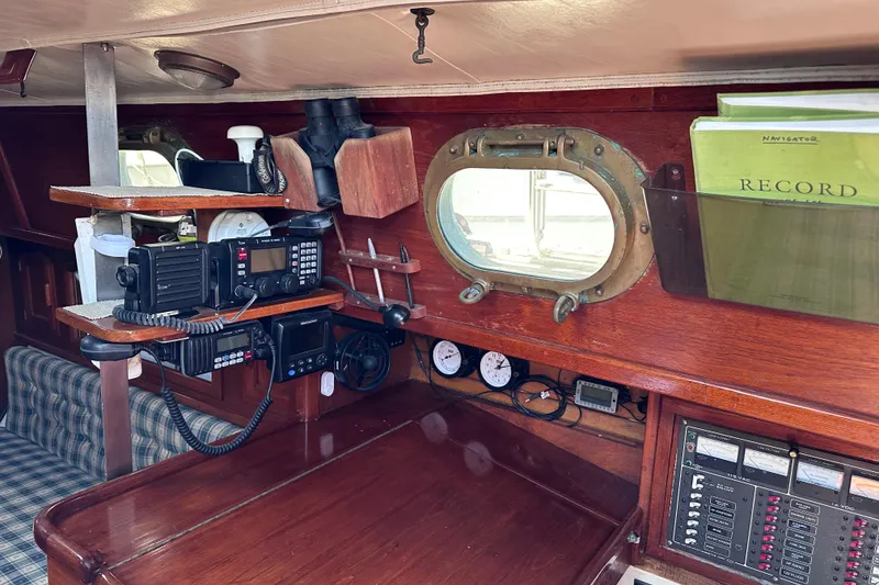 Slide: The Image of Interior of 1986 Pacific Seacraft 34 sailboat with navigation equipment and wooden finish. - 25
