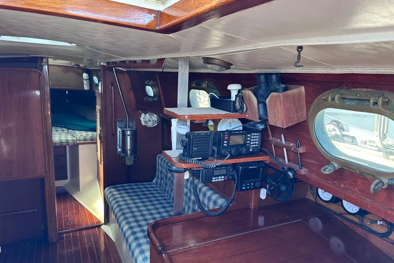 Slide: The Image of Interior of 1986 Pacific Seacraft 34 sailboat with navigation equipment and cozy seating. - 30