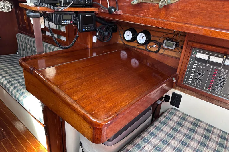 Slide: The Image of Navigation station of a 1986 Pacific Seacraft 34 sailboat with wooden desk and instruments. - 33