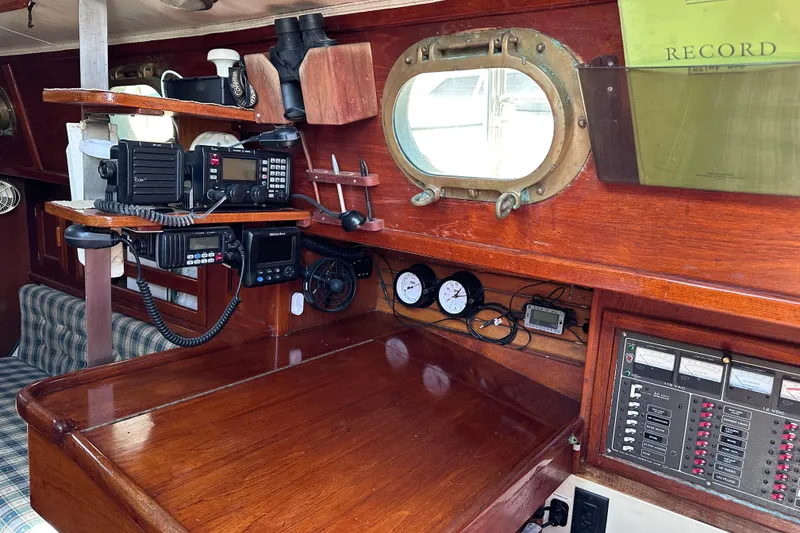Slide: The Image of 1986 Pacific Seacraft 34 interior with navigation equipment and wooden cabinetry. - 34