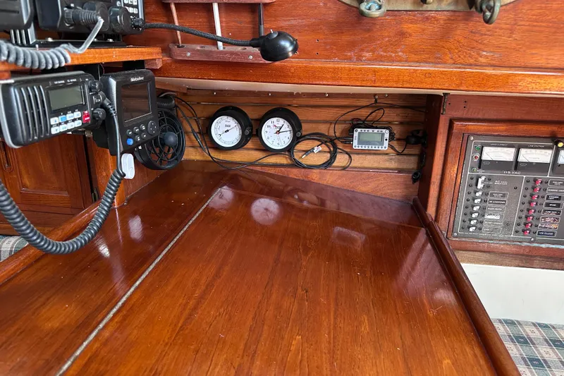 Slide: The Image of Navigation equipment and control panel inside a 1986 Pacific Seacraft 34 sailboat cabin. - 35