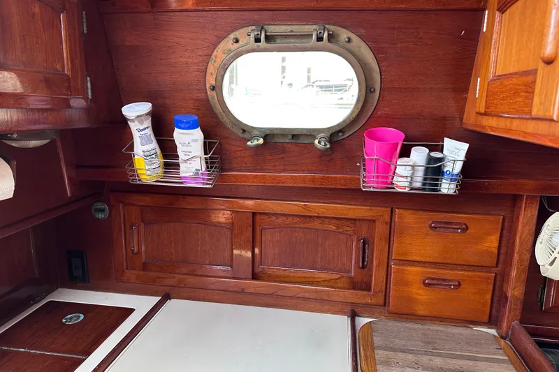 Slide: The Image of Interior of 1986 Pacific Seacraft 34 sailboat with wooden cabinetry and porthole window. - 38