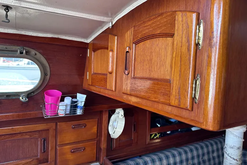 Slide: The Image of Interior of 1986 Pacific Seacraft 34 sailboat with wooden cabinets and porthole. - 41
