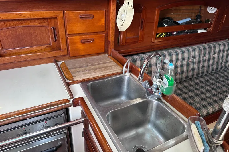 Slide: The Image of Interior of 1986 Pacific Seacraft 34 sailboat with wooden cabinetry and dual sink. - 42