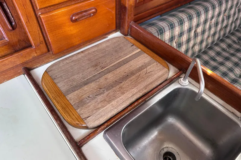Slide: The Image of Wooden galley countertop and sink in 1986 Pacific Seacraft 34 sailboat interior. - 45
