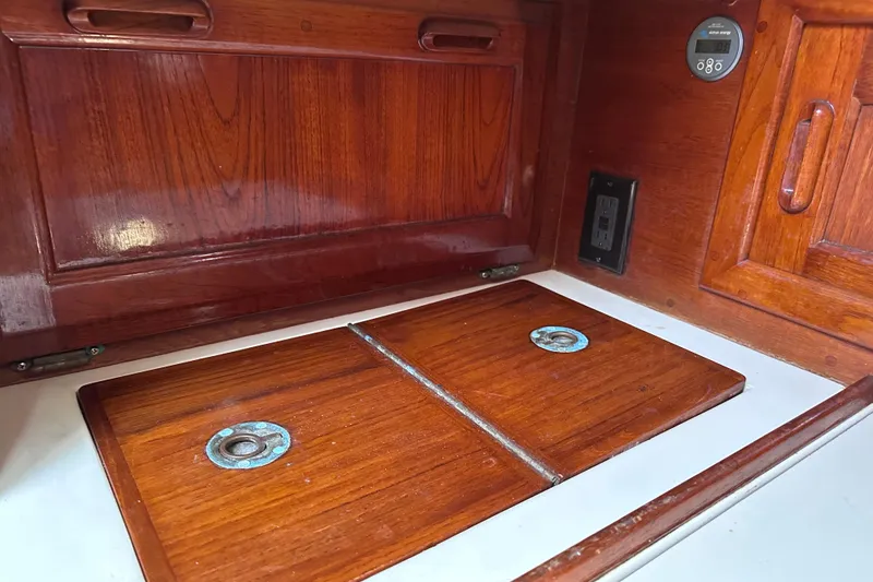 Slide: The Image of Wooden interior of 1986 Pacific Seacraft 34 sailboat, featuring storage compartments. - 47