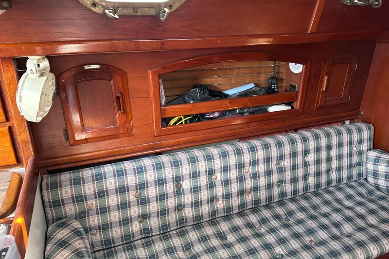 Slide: The Image of Interior of 1986 Pacific Seacraft 34 sailboat with plaid upholstery and wooden cabinetry. - 50