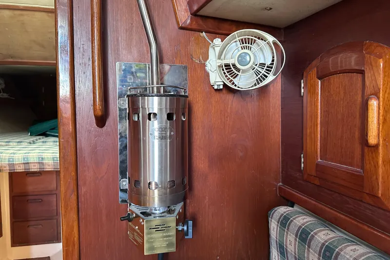 Slide: The Image of Cozy cabin interior of 1986 Pacific Seacraft 34 with heater and fan. - 52